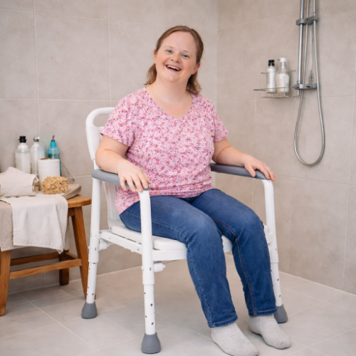 lady demonstrating how to use a commode (fully clothed)
